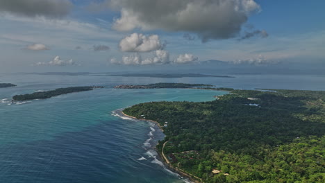 bocas del toro panama aerial v7 cinematic reverse flyover capturing paunch beach, beautiful island seascape and lush green natural reserve on a idyllic spring day - shot with mavic 3 cine - april 2022