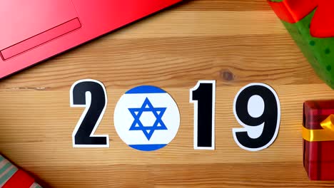 ilustración, año nuevo, mano masculina puesta sobre la mesa en la bandera israelí, balón del país, 2019