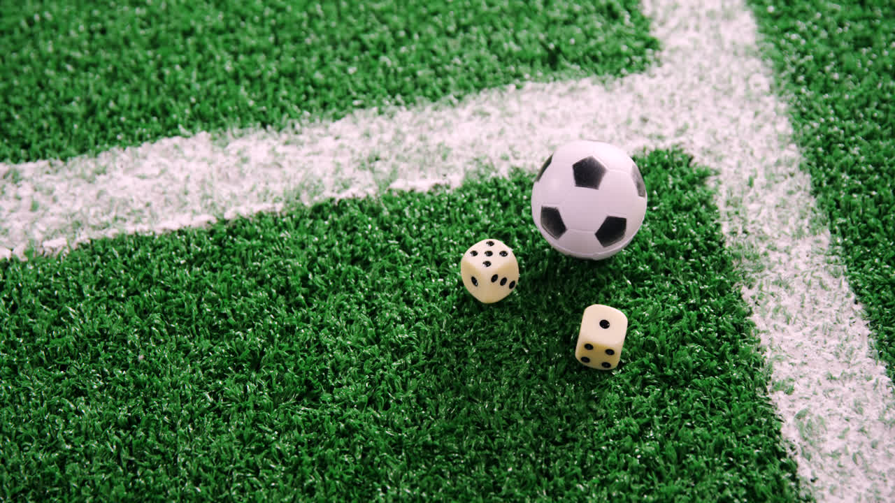 Pallone da calcio e dadi su erba artificiale 4k