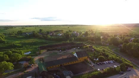 aerial view of a horse farm at sunset