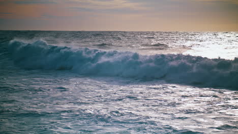 Schaumige-Wellen-Rollen-In-Zeitlupe-Bei-Sonnenaufgang-Ans-Ufer.-Wunderschöne-Aussicht-Auf-Das-Meer-Am-Abend.