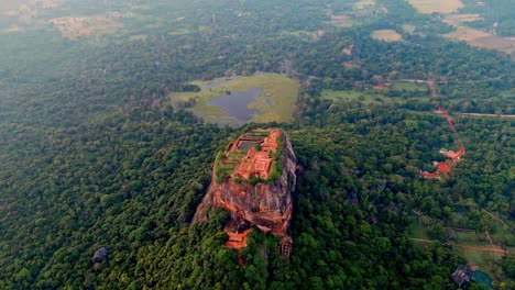 stunning drone footage capturing the iconic sigiriya rock fortress and nearby lake at sunrise in sri lanka.