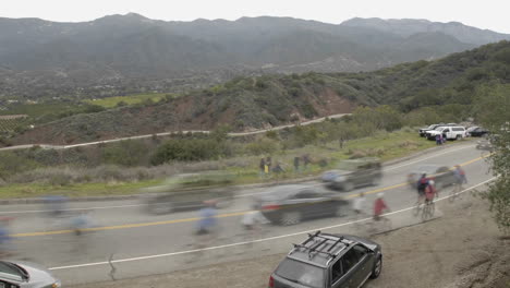 peloton in slow motion during a time lapse of the 2008 tour of california bike race passing over dennison grade in ojai california