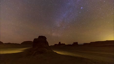 Bright-Meteor-at-the-Night-sky-full-of-stars-and-milky-way-galaxy-shines-in-a-starry-dark-landscape-Lut-desert-at-night-in-Iran-central-climate-landscape-of-landmark-and-landform-of-sand-blast-rocks