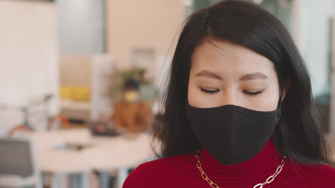 Asian Woman Wearing Face Mask in Workplace