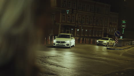 Female-face-looking-city-with-cars-driving-street-at-late-night.