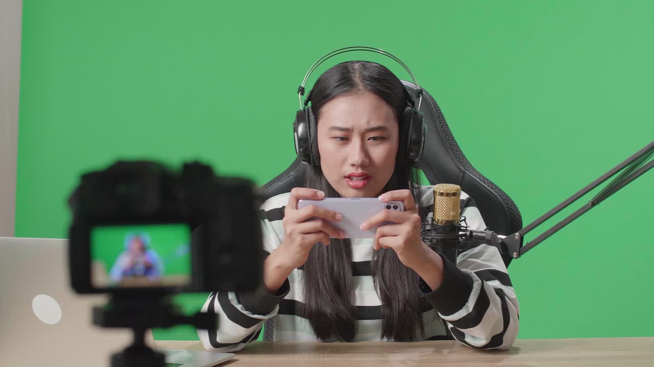 Woman Playing Mobile Game in a Green Screen Studio