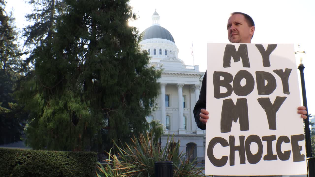 내 몸을 가진 남성 정치 시위자 내 선택 기호 슬라이더 돌리 추적 샷