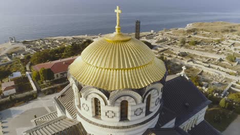 aerial view of a golden domed church with ancient ruins