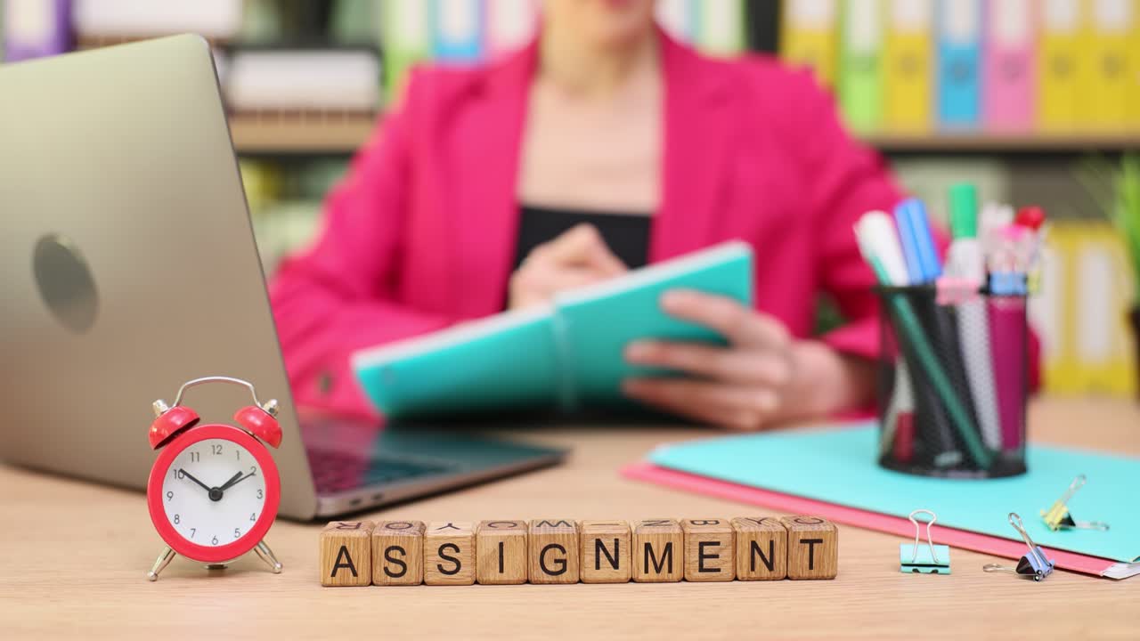 Assignment Time: Woman Working at Desk with Laptop and Notebook