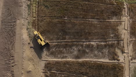 Birds-Eye-Aerial-View-Of-A-Combine-Harvester-Working-In-Punjab-Field-In-Pakistan