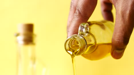 Pouring-sunflower-oil-in-a-cup-on-table