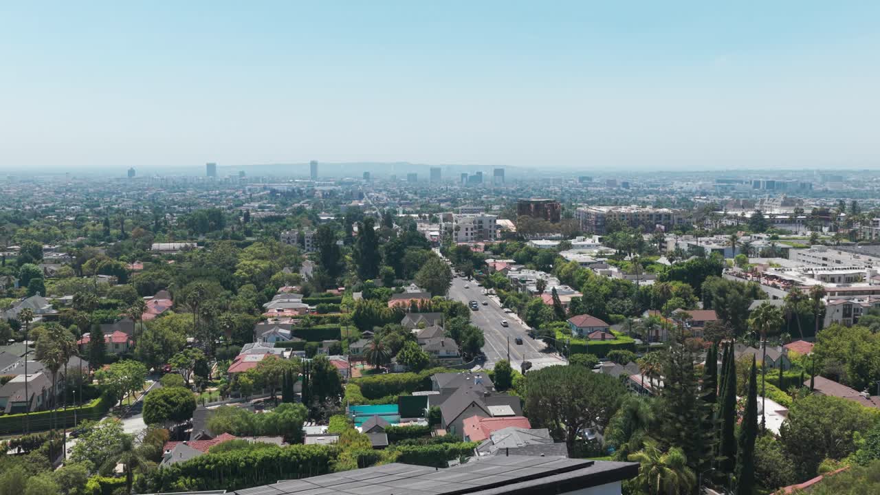 Low rising aerial shot of the Los Angeles basin as seen from a hillside home in the Hollywood Hills, California. 4K