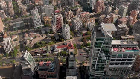 Aerial-reveal-of-street-from-buildings-perspective-in-luxury-district,-Santiago-de-Chile-4K
