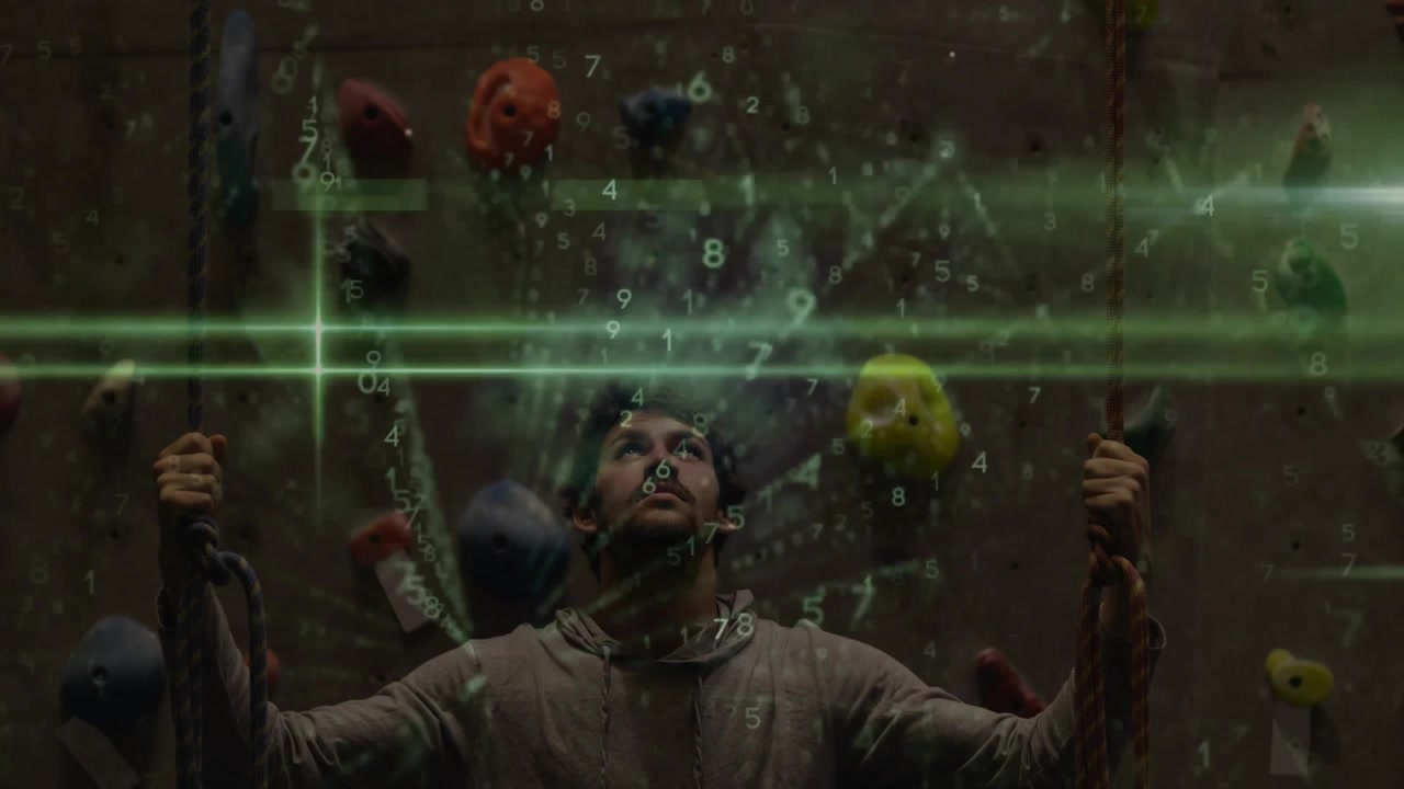 Man Looking Up at Climbing Wall with Digital Data Overlay