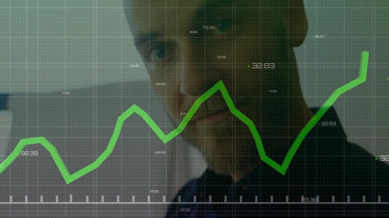 Businessman typing on laptop initiating chart animating, camera panning up revealing analysis focus