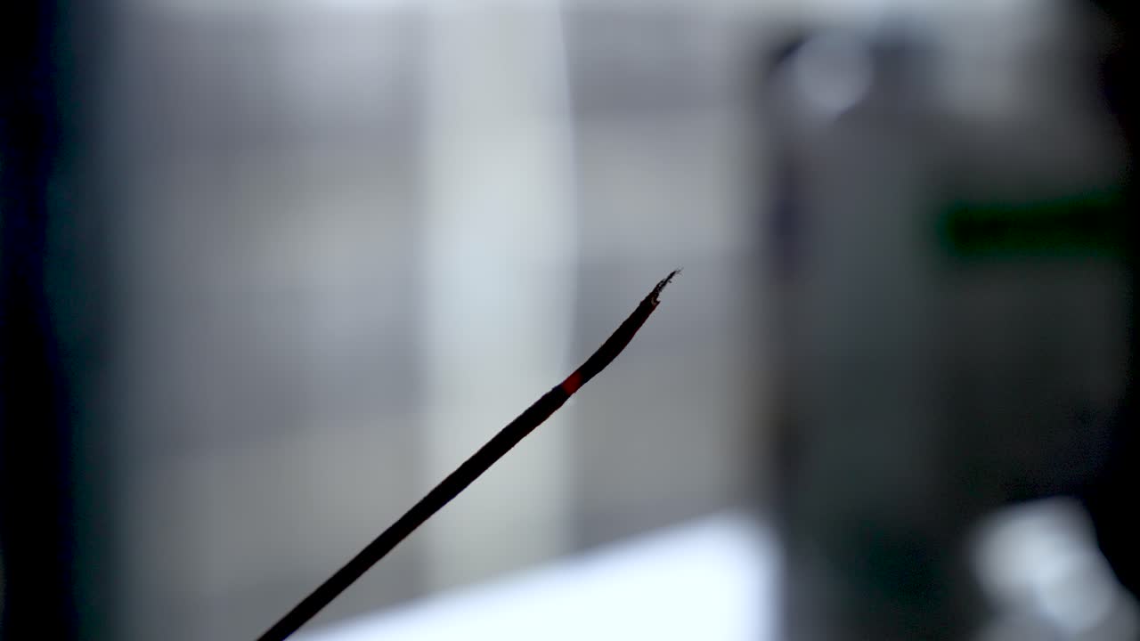 Incense stick burning, creating white smoke for meditation and relaxation