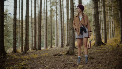 young woman standing in forest during vacation