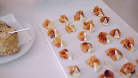 delicate smoked salmon and cheese appetizers on white plate