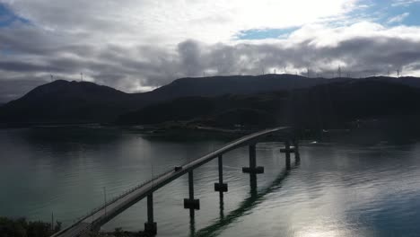 cinematic shot of a car driving across a bridge in norway