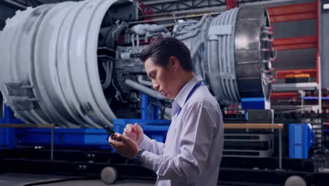 engineer using smartphone in factory