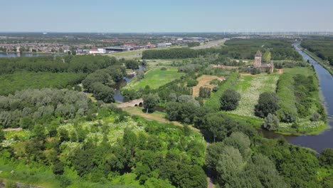 aerial drone shot above a nature park, water canal, abandoned kastel of almere city, province flevoland, netherlands