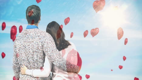 couple holding each other and looking at the sky together