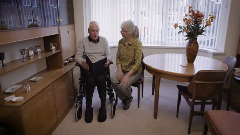 an elderly couple reading together