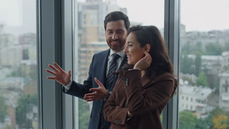 Smiling-businessman-talking-woman-partner-showing-office-work-closeup.-Coworkers