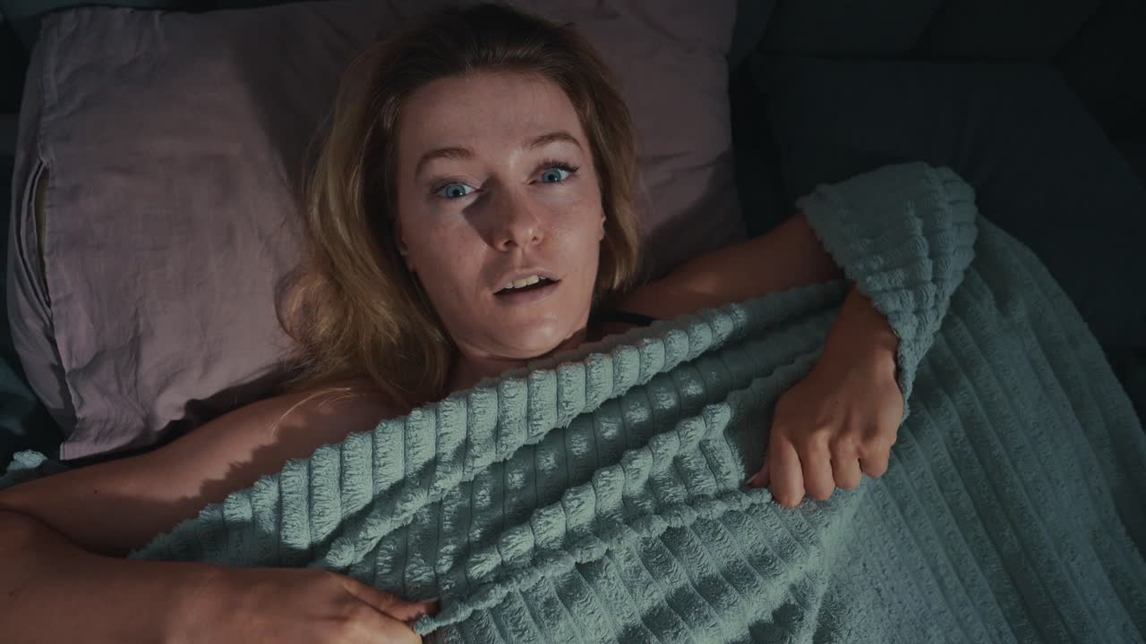 Woman startled in bed at night