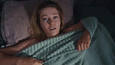 woman startled in bed at night