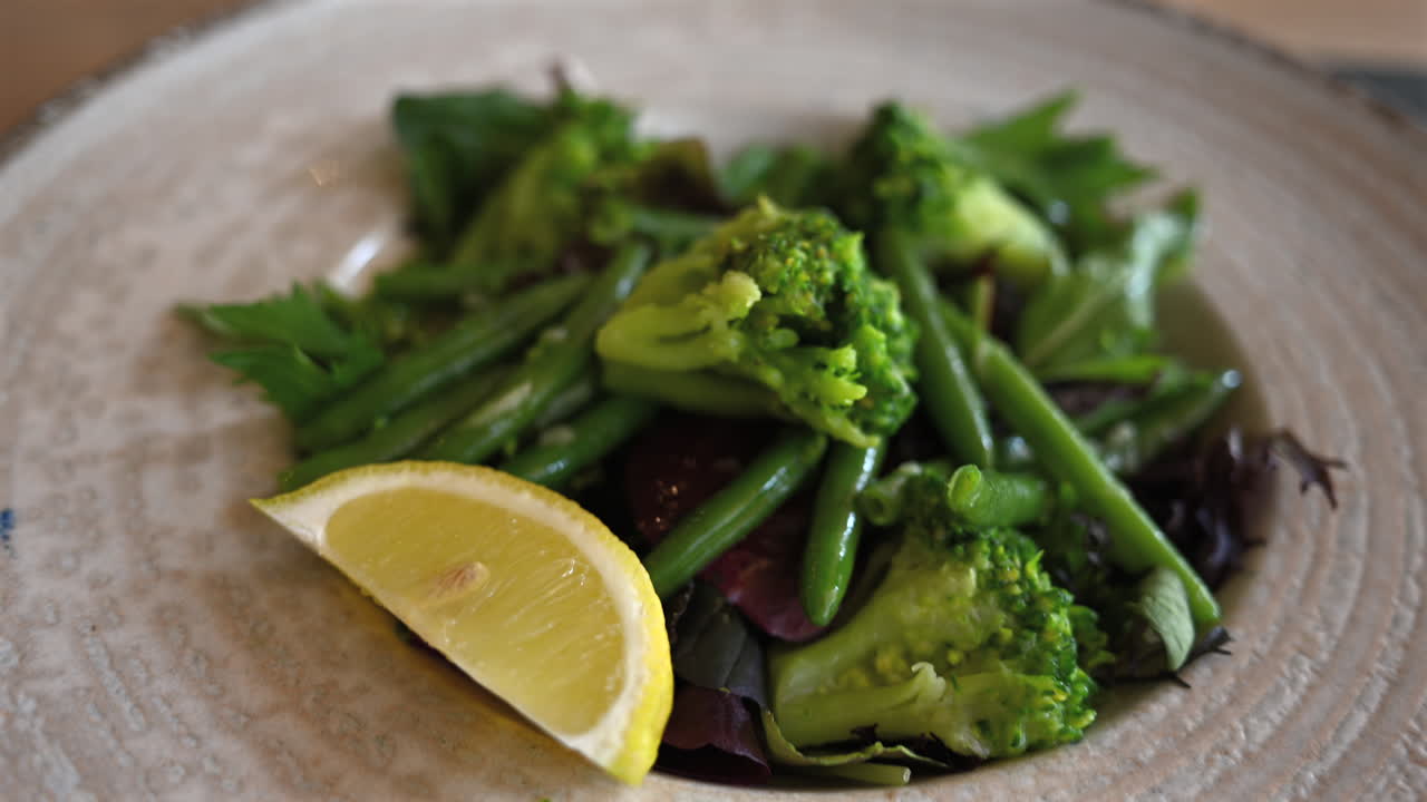 Fresh salad with broccoli, green beans, and mixed greens served in bowl