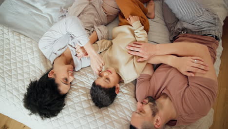 happy, love and family relaxing on bed