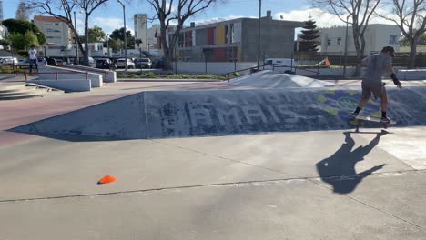 man rides carver skateboard, practicing skateboard riding style and tricks, slow motion