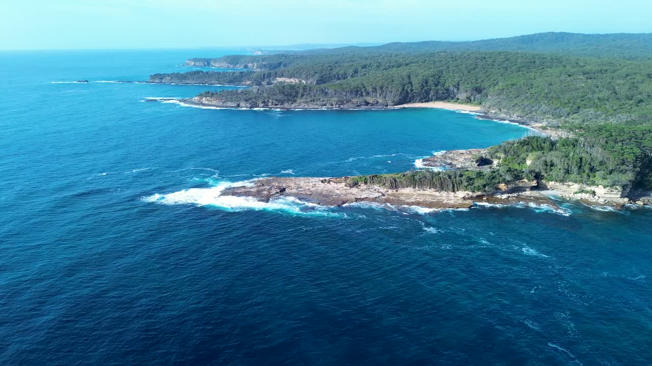 Drone aerial landscape of ocean coastline bay with bushland forest Wasp Island South Durras Emily Miller Beach Australia waves headland travel tourism