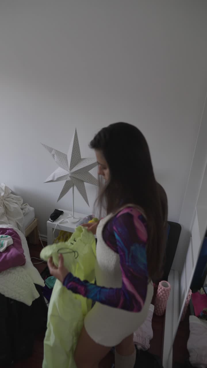 Woman packing clothes in a messy bedroom