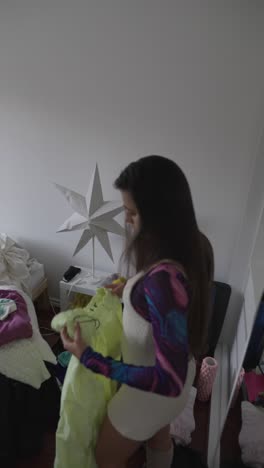 woman packing clothes in a messy bedroom