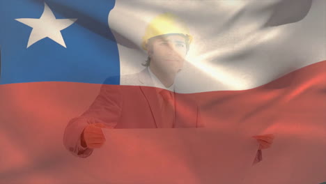 animation of chile flag, caucasian engineer wearing helmet standing and looking at blueprint