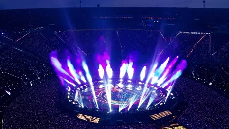 a large crowd of people watching a concert at a stadium at night