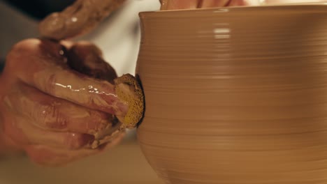 artisan shaping clay on a pottery wheel