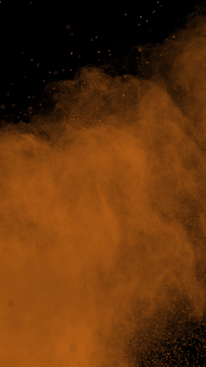 Super Slow Motion Shot of Orange Color Powder Explosion at 1000Fps Vertical View