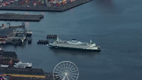 High-up-aerial-view-of-the-Bainbridge-ferry-docking-in-downtown-Seattle