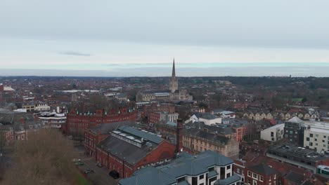 norwich cityscape with church spire, turrets, streets, and shops, aerial view