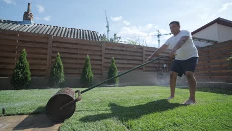 man laying sod grass in backyard garden for lawn installation and landscaping project, focused on home improvement and outdoor maintenance for a fresh, green lawn in a residential yard