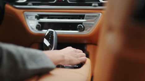 woman hand touching automatic gear shift