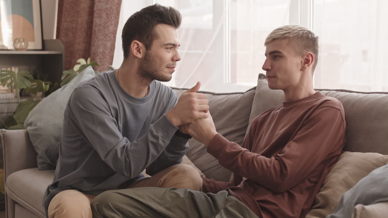 Two Young Loving Men Holding Hands of Each Other