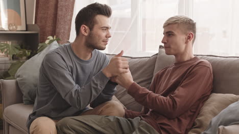 two young loving men holding hands of each other