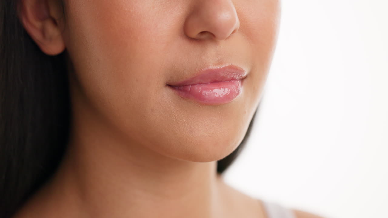 Close-up of a woman's face with glossy lips