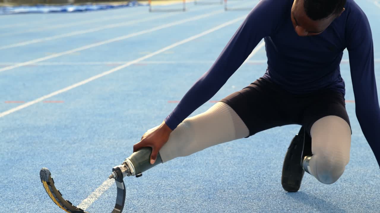 Disabled athletic exercising on a running track 4k