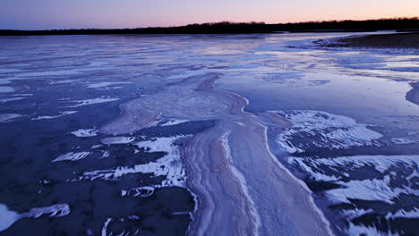 stunning footage as a drone glides over immense ice formations in a river